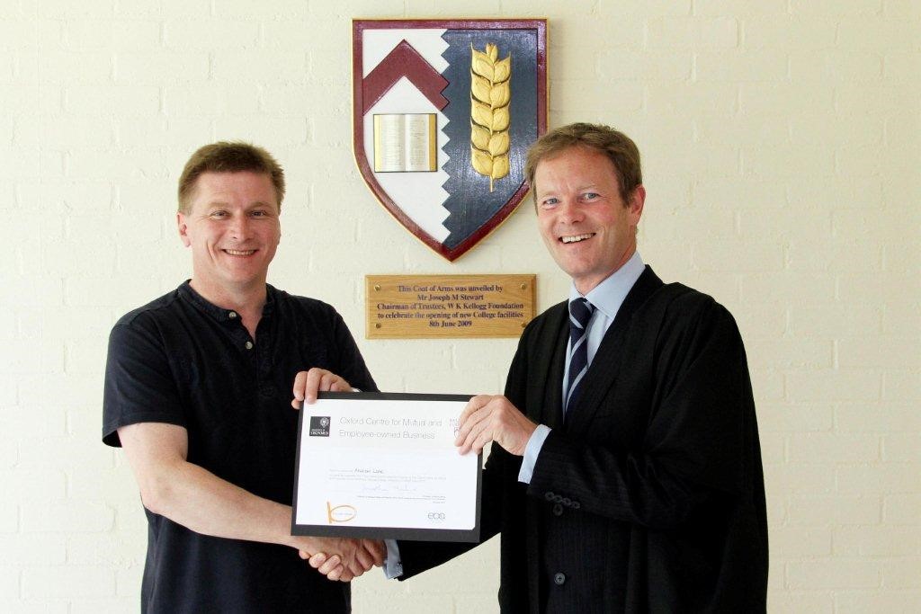 Picture of Andrew Lane receiving certificate from another male 